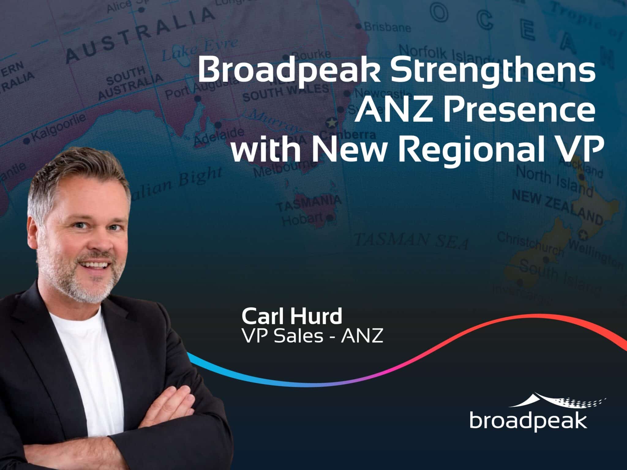 Carl Hurd, Broadpeak’s VP Sales for Australia and New Zealand (ANZ), stands with folded arms in front of a map of Australia and New Zealand. The image features the headline “Broadpeak Strengthens ANZ Presence with New Regional VP” and the Broadpeak logo, highlighting the company’s expanded regional leadership presence in ANZ.